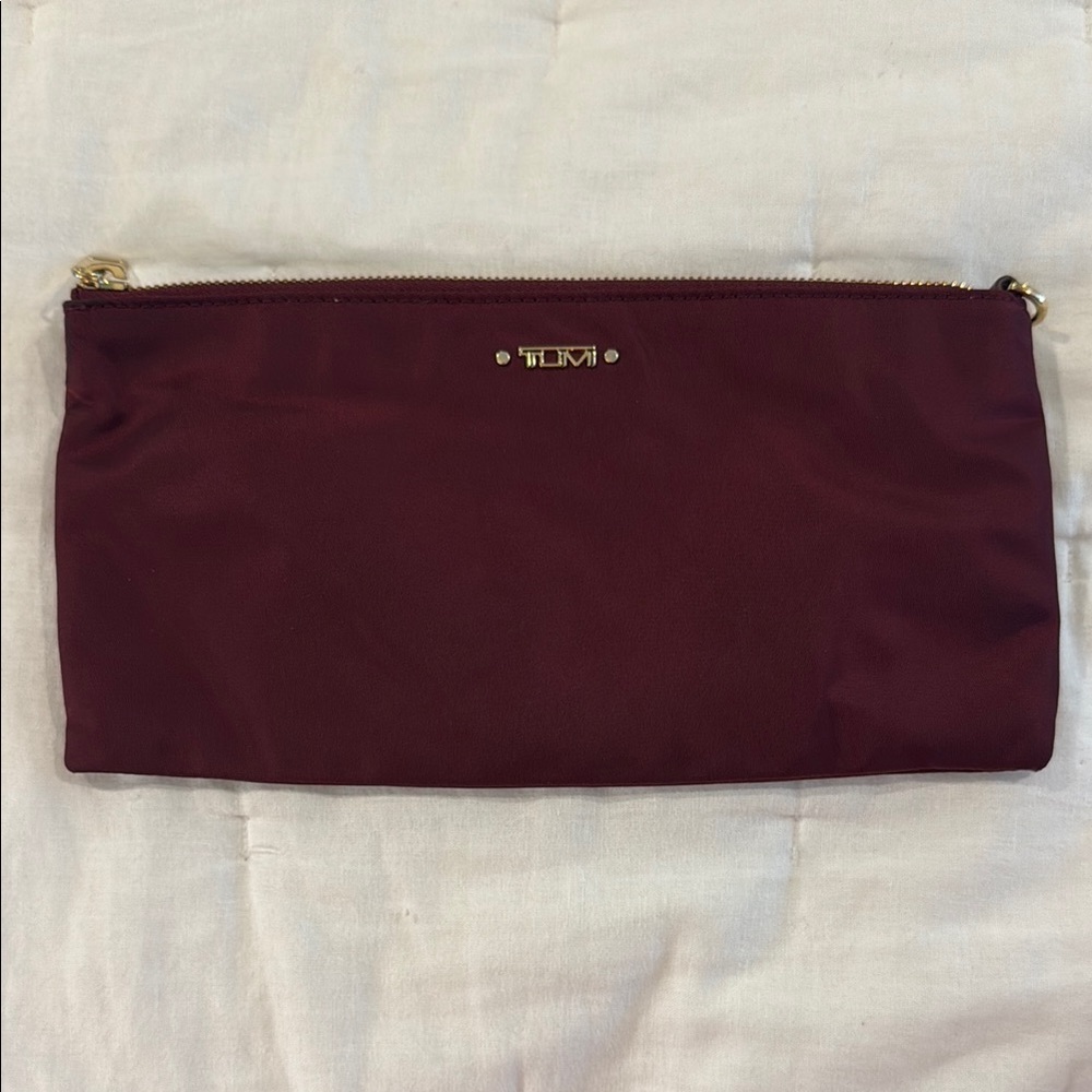 TUMI maroon and gold zipper pouch